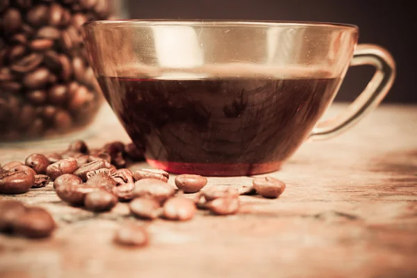 Cup of black coffee with beans — Stock Photo, Image