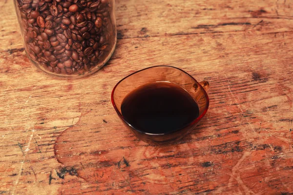 Cup of coffee and jar of beans — Stock Photo, Image