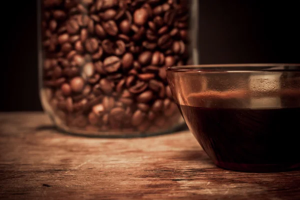 Cup of coffee and jar of beans — Stock Photo, Image