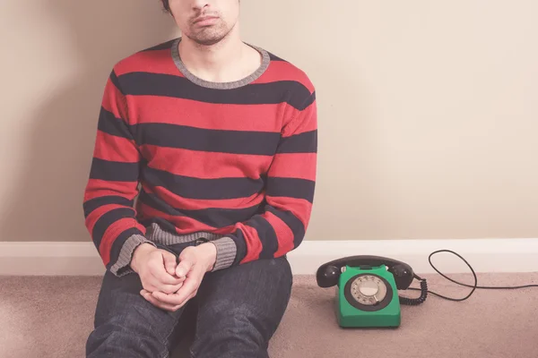 Man on floor with telephone — Stock Photo, Image