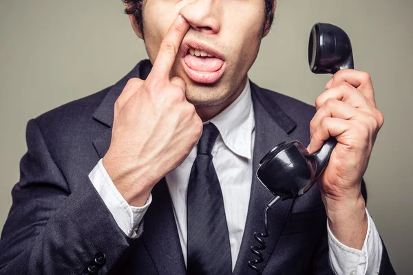 Businessman picking his nose — Stock Photo, Image