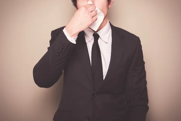 Businessman blowing his nose — Stock Photo, Image