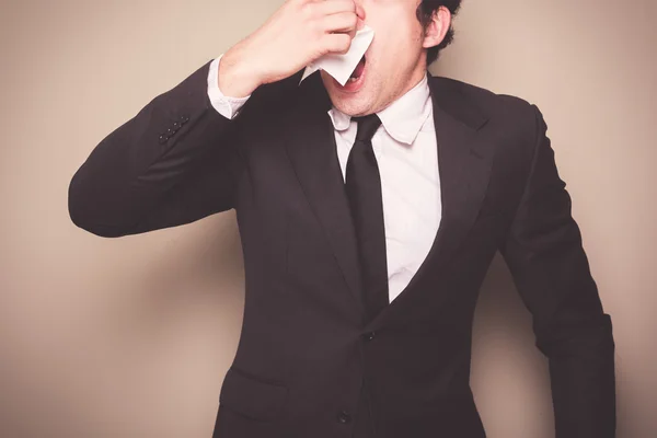 Businessman sneezing — Stock Photo, Image