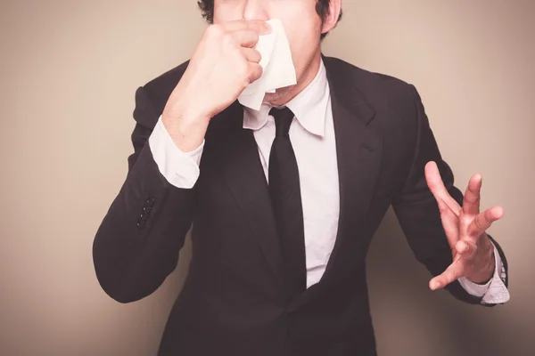 Businessman sneezing — Stock Photo, Image