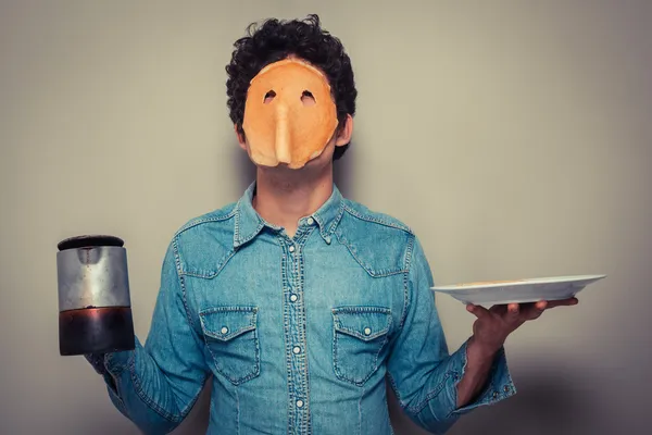 Man with pancake on his face and coffee — Stock Photo, Image