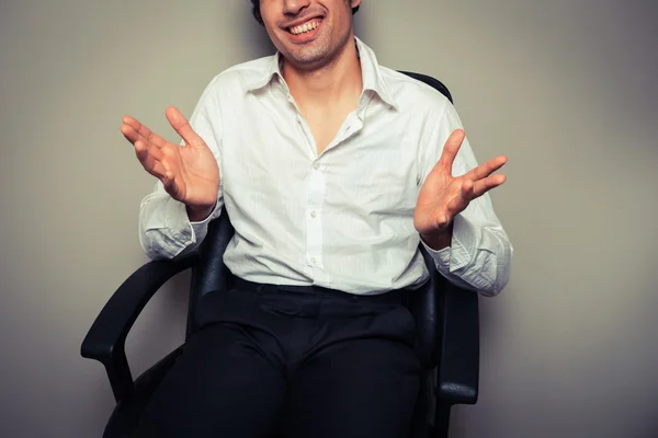 Casual young businessman in office chair — Stock Photo, Image