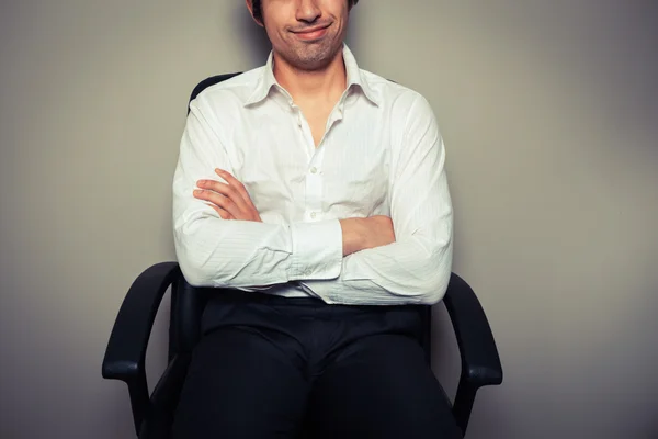 Casual jonge zakenman in stoel van het Bureau — Stockfoto