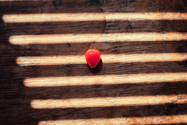 Unusual heartshaped tomato on wood table — Stock Photo, Image