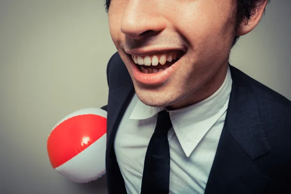 Happy businessman with beach ball — Stock Photo, Image