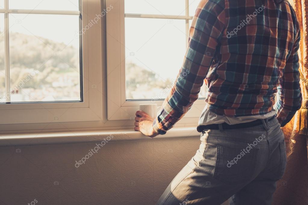 Young woman looking out the window