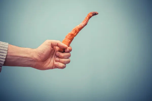 Hand holding rotten carrot — Stock Photo, Image