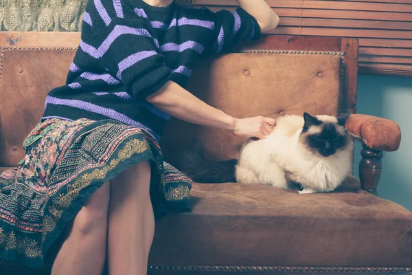 Mujer joven y gato en el sofá —  Fotos de Stock