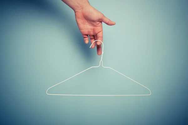 Hand holding wire hanger — Stock Photo, Image