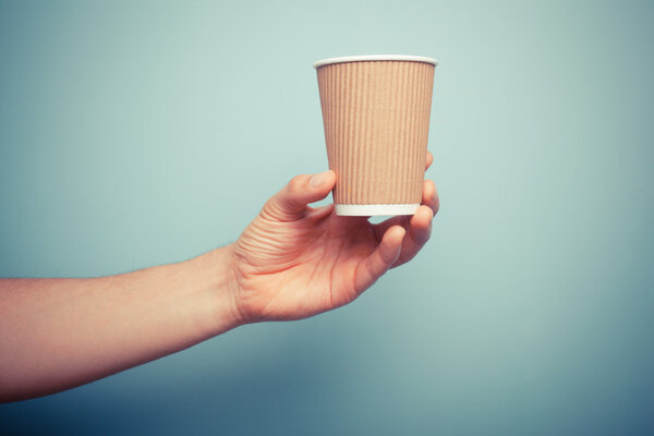 Man holding paper cup