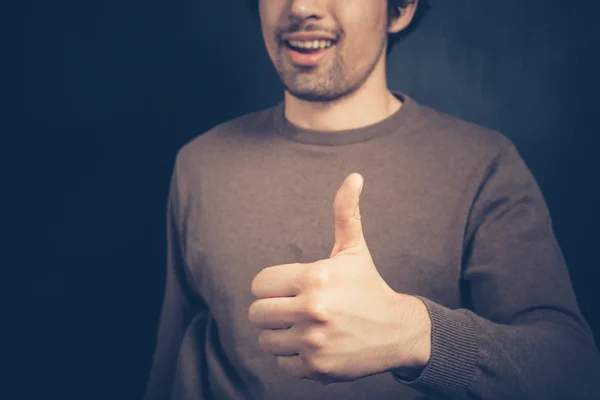 Young man giving thumb up — Stock Photo, Image