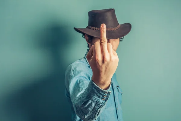 Cowboy zeigt obszöne Geste — Stockfoto