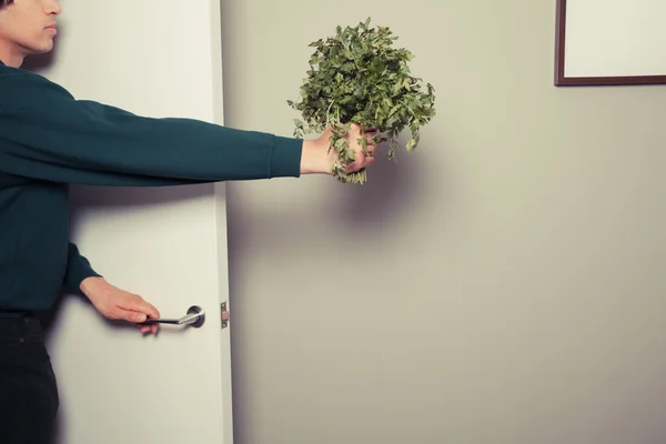 Anak muda memasuki rumah dengan parsley — Stok Foto