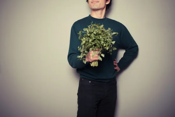 Joyeux jeune homme avec un gros bouquet de persil — Photo