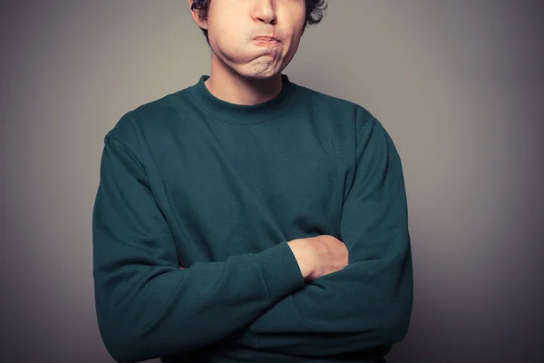 Mladý muž tahání hloupé tváře — Stock fotografie