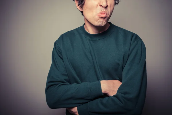 Young man pulling silly faces — Stock Photo, Image