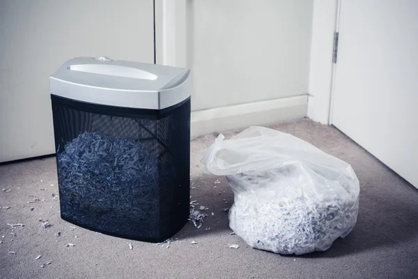 Paper shredder and bag of shredded documents — Stock Photo, Image