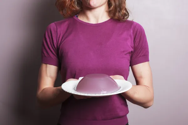 Young woman in purple top with a plate of pudding — Stock Photo, Image