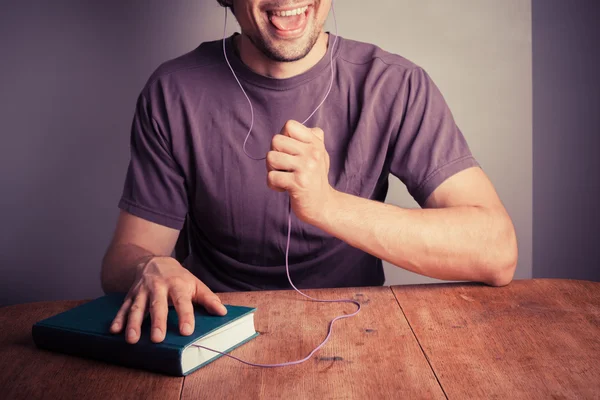 Young man listening to audio book — Stock Photo, Image