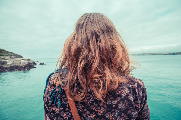 Young woman by the water's edge
