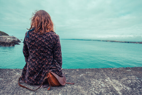Young woman by the water's edge