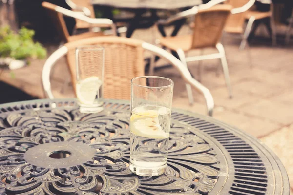 Two glasses on a table in garden — Stock Photo, Image