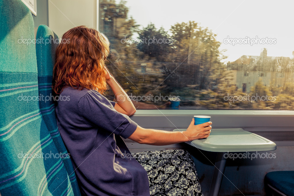 Young woman sitting on train