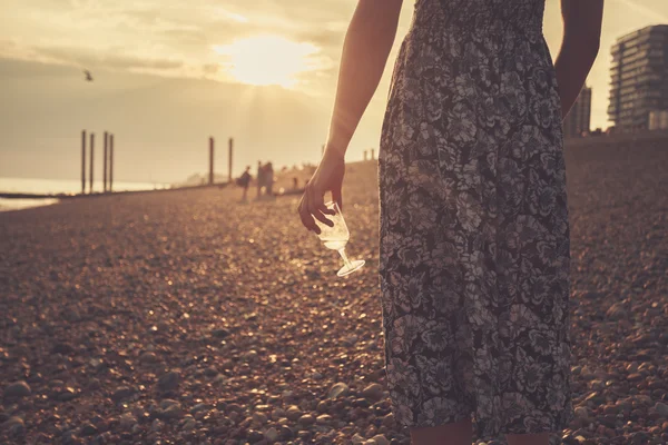 Young woman on the beach with glass of wine — Stock Photo, Image