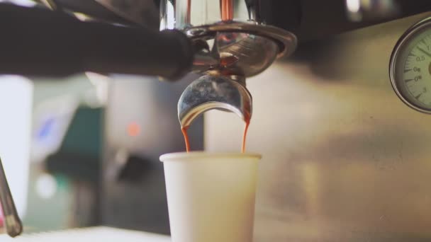 4k, καφέ espresso ρίχνει από τη μηχανή του καφέ σε ένα λευκό χάρτινο κύπελλο, αργή κίνηση — Αρχείο Βίντεο
