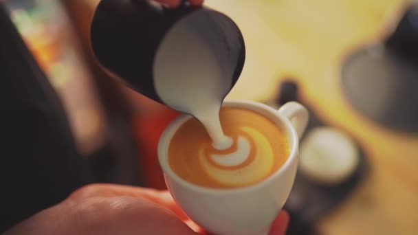 4k, barista pouring milk into espresso coffee for making cappuccino, latte art, slow motion — Stock Video