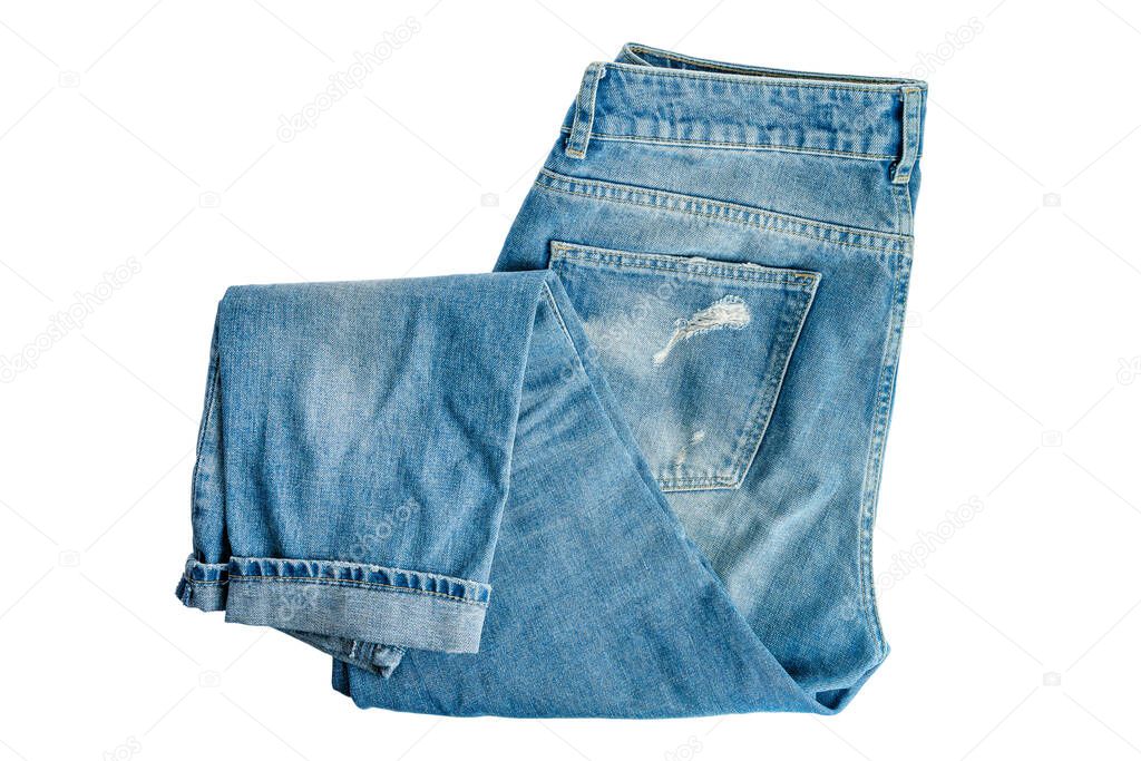 Denim trousers folded in half, modern trends, fashion, casual style, isolated on a white background, close-up