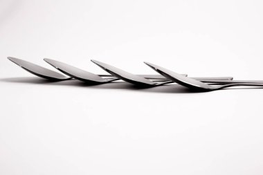 Chicken egg on metal forks, spoons isolated on white background close-up.An egg that is set on top of two forks, spoons. Eggs have so many uses from diet to baking recipes.