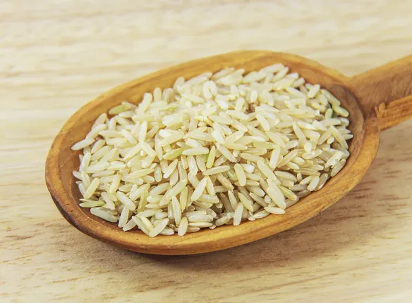 Brown Rice on wooden spoon — Stock Photo, Image