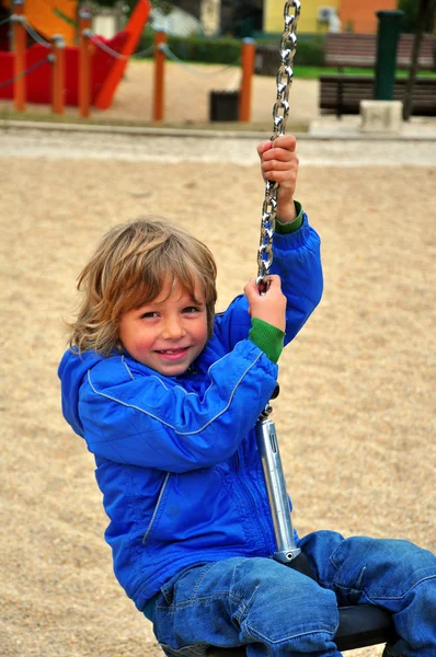Happy boy swinging — Stock Photo, Image