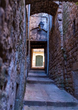 A passageway in the town of Joyeuse located in Southern France, taken on a sunny summer morning with no people