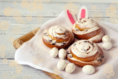 Paskalya yumurtası ve dekoru taze çörekler ve beyaz şekerli spiraller..