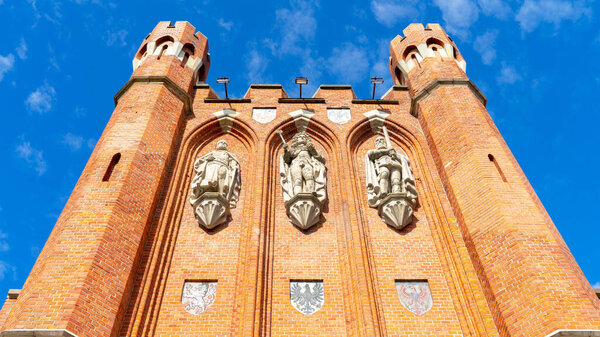 Bas-relief and coats of arms on the facade of the red brick King's Gate, Kaliningrad, Russia. Bas-reliefs of King Otakar II of Bohemia, King of Prussia Frederick I and Duke of Prussia Albrecht I.