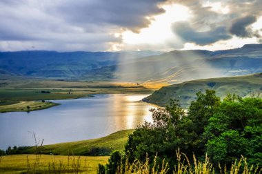 Maloti Drakensberg dağları ve KZN 'deki çan parkı barajı üzerindeki güneş ve güneş ışınları