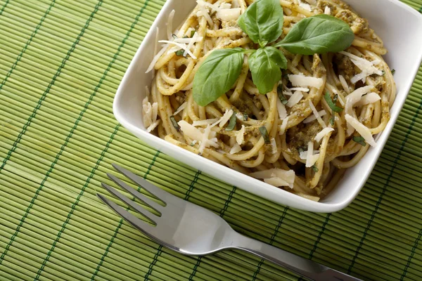 Italian pasta with pesto sauce and parmesan. — Stock Photo, Image