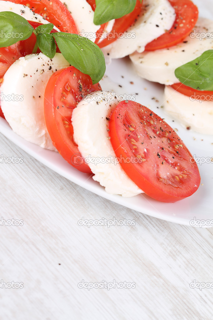 Tomato and mozzarella with basil leaves salad