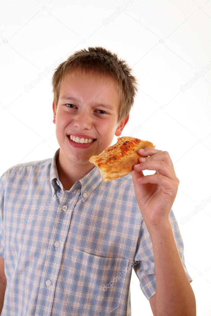 Young boy eating pizza