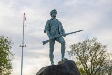 Minute Man Statue in Battle Green in historic town center of Lexington, Massachusetts MA, USA.  clipart