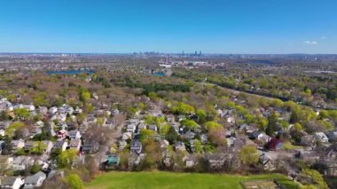 Arlington Heights suburban landscape aerial view in spring with Spy Pond and Boston modern city skyline at the background in historic town of Arlington, Massachusetts MA, USA. 
