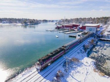 MBTA Commuter Rail General Motors EMD F40PH locomotive on the bridge at Manchester Harbor in historic town center of Manchester-by-the-Sea, Massachusetts MA, USA. 