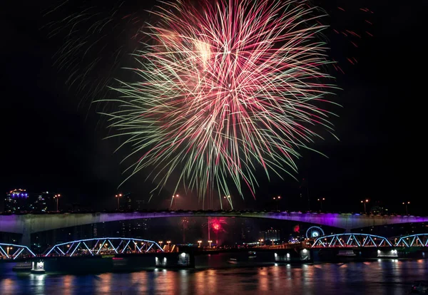 The wonderful Fireworks light up into the sky, look through the beautiful bridges and rivers with free space for text. Selective focus.