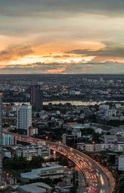 Bangkok, Tayland - 30 Ağustos 2021: Bangkok 'taki büyük metropol şehri üzerinde turuncu ve mavi gökyüzü bulutlu güneşin doğuşunun ya da batışının muhteşem manzarası. Boşluğu kopyala, Seçici odak.